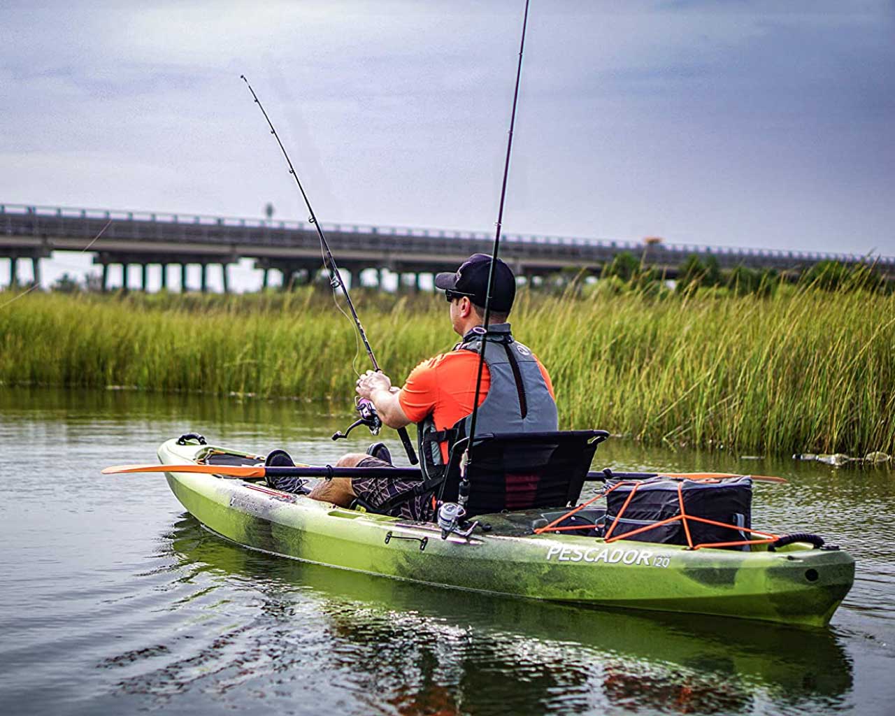 A fisherman fishing from a fishing kayak